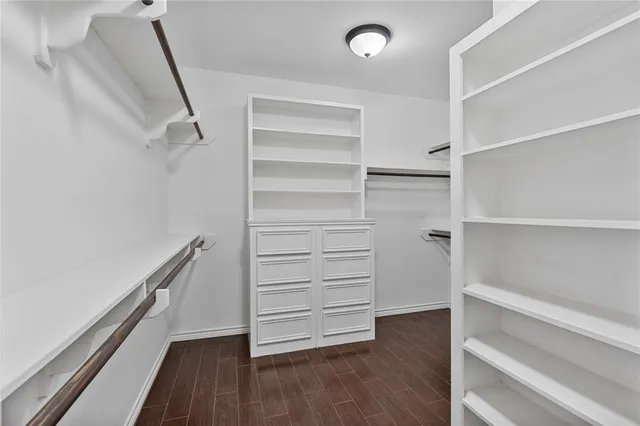 a view of walk in closet with empty racks