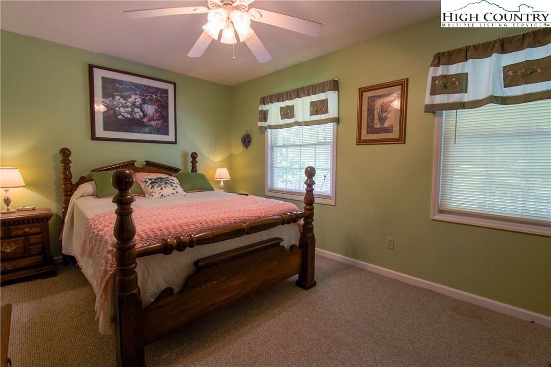 581 North Fork New River Road Lansing, NC 28643 - Photo 27 of 44 a bedroom with a bed and a painting on the wall