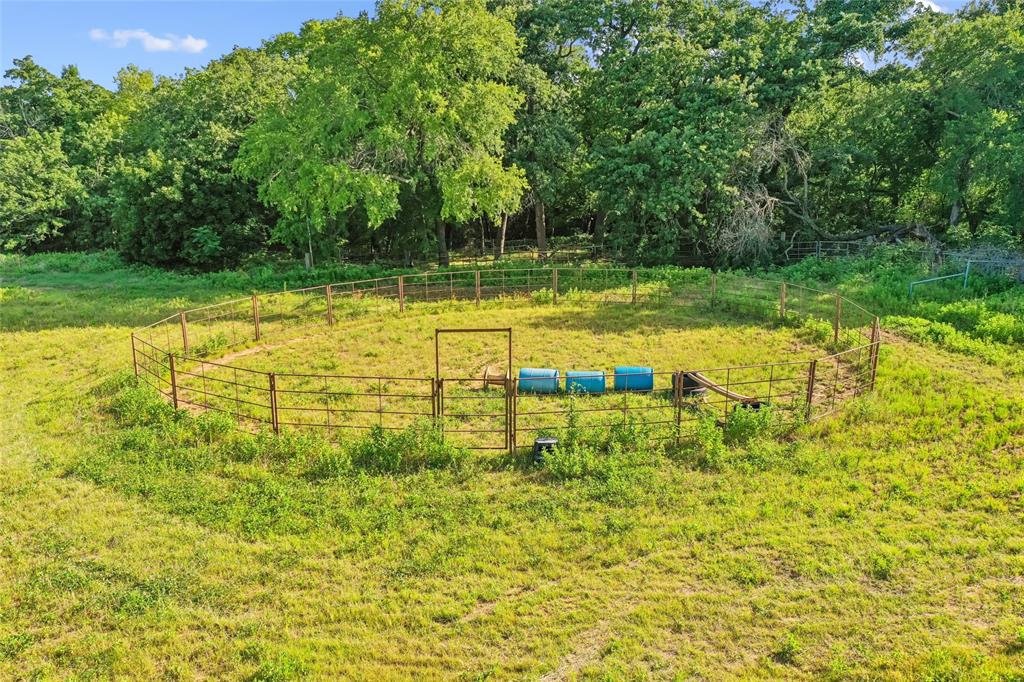 3030 Wager Road Flower Mound, TX 75028 - Photo 32 of 40 Fenced circular enclosure with surrounding natural foliage and expansive grassy areas