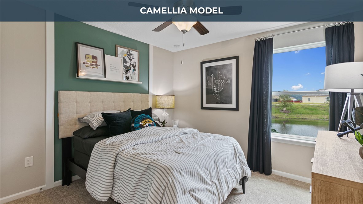 65760 Edgewater Drive Yulee, FL 32097 - Photo 13 of 35 a bedroom with bed and a chandelier