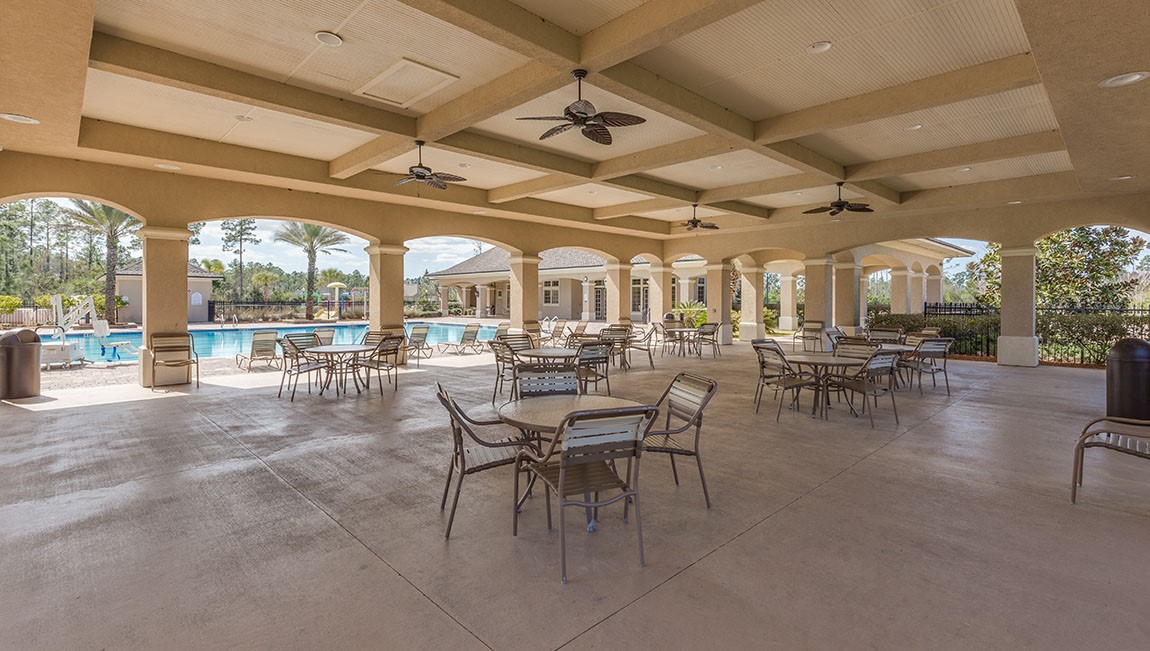 65760 Edgewater Drive Yulee, FL 32097 - Photo 24 of 35 a outdoor space with lots of white furniture a chandelier and a glass door