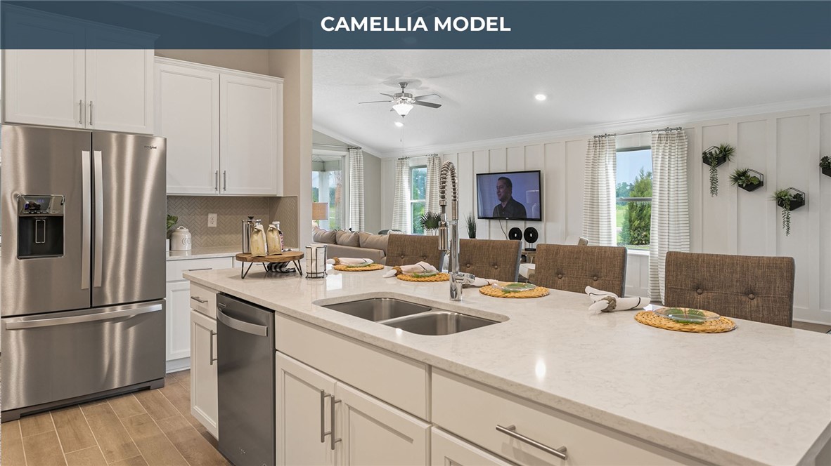 65760 Edgewater Drive Yulee, FL 32097 - Photo 7 of 35 a kitchen with a sink a stove and refrigerator