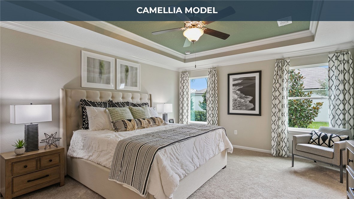 65760 Edgewater Drive Yulee, FL 32097 - Photo 9 of 35 a spacious bedroom with a bed a couch and a window