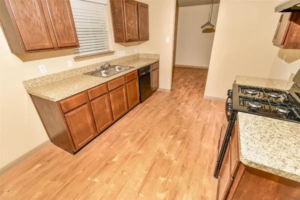 a kitchen with a sink stove and cabinets