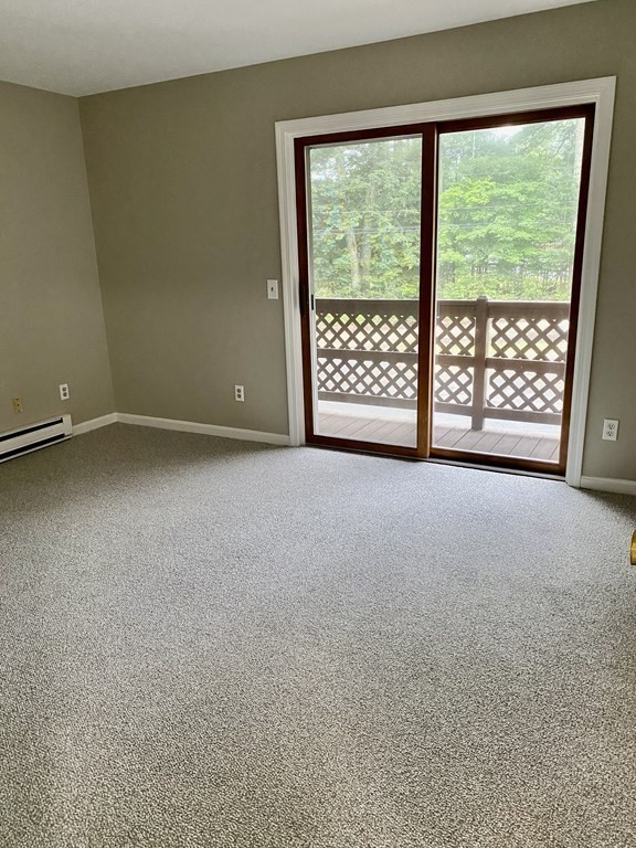 13 May Brook Road, Unit 13 Holland, MA 01521 - Photo 24 of 36 a view of an empty room with a balcony