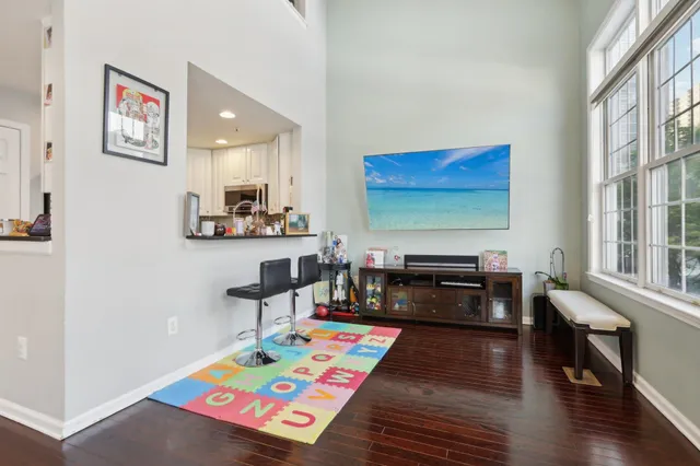 a living room with furniture and a floor to ceiling window