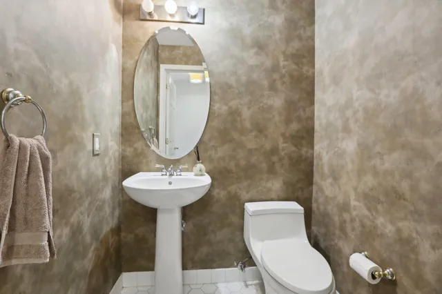 a white toilet sitting next to a bathroom sink