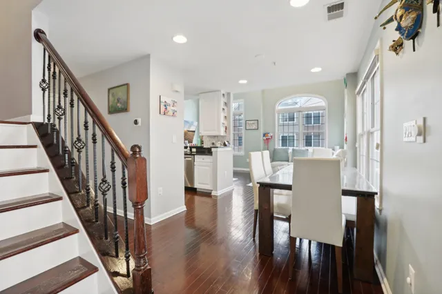 a dining room with furniture and wooden floor