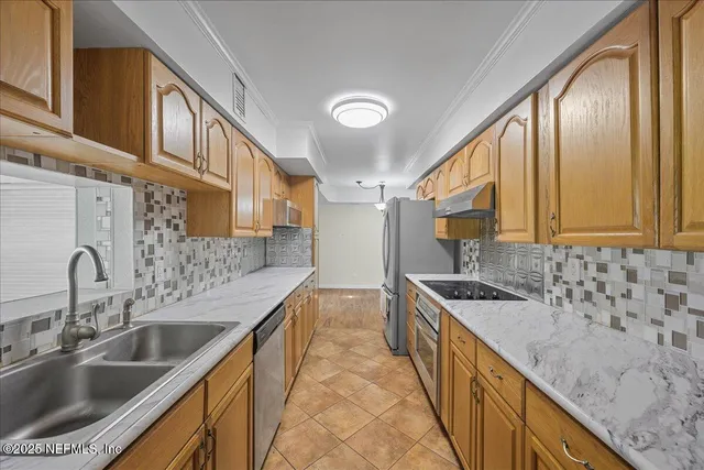 a kitchen with stainless steel appliances granite countertop a sink stove and cabinets