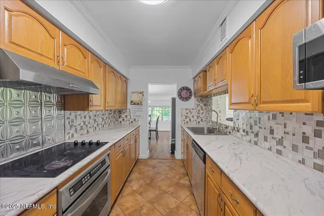 a kitchen with stainless steel appliances granite countertop a sink and a stove