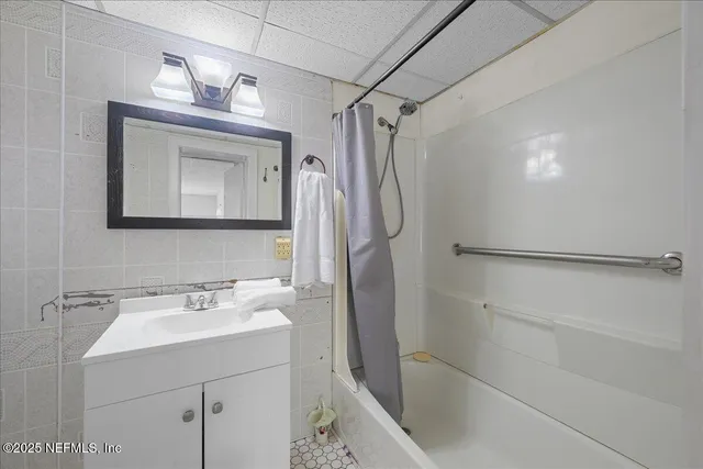 a bathroom with a sink mirror toilet and shower