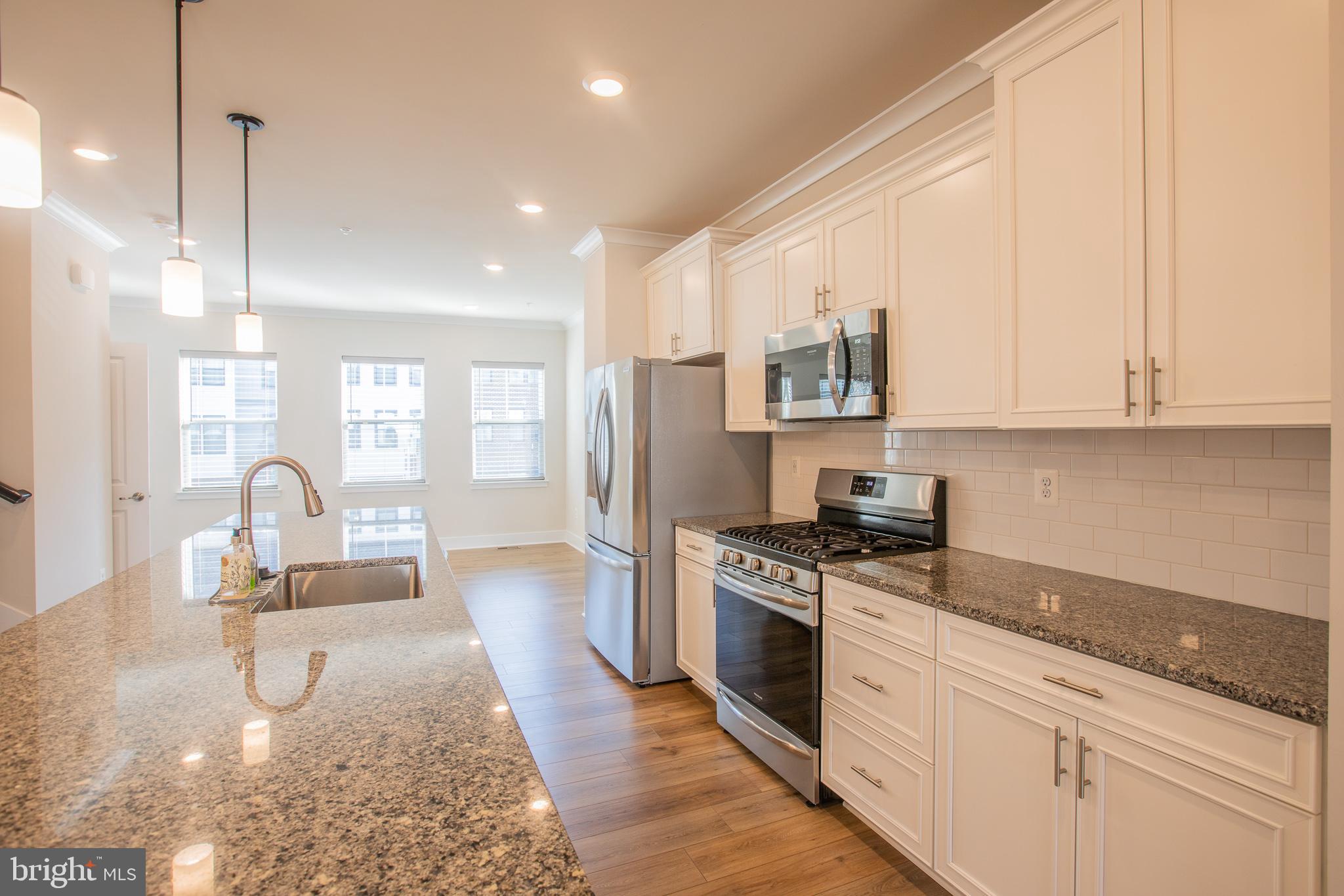 826 Teacher MItchell Road Glen Burnie, MD 21060 - Photo 11 of 41 a kitchen with sink stove and cabinets