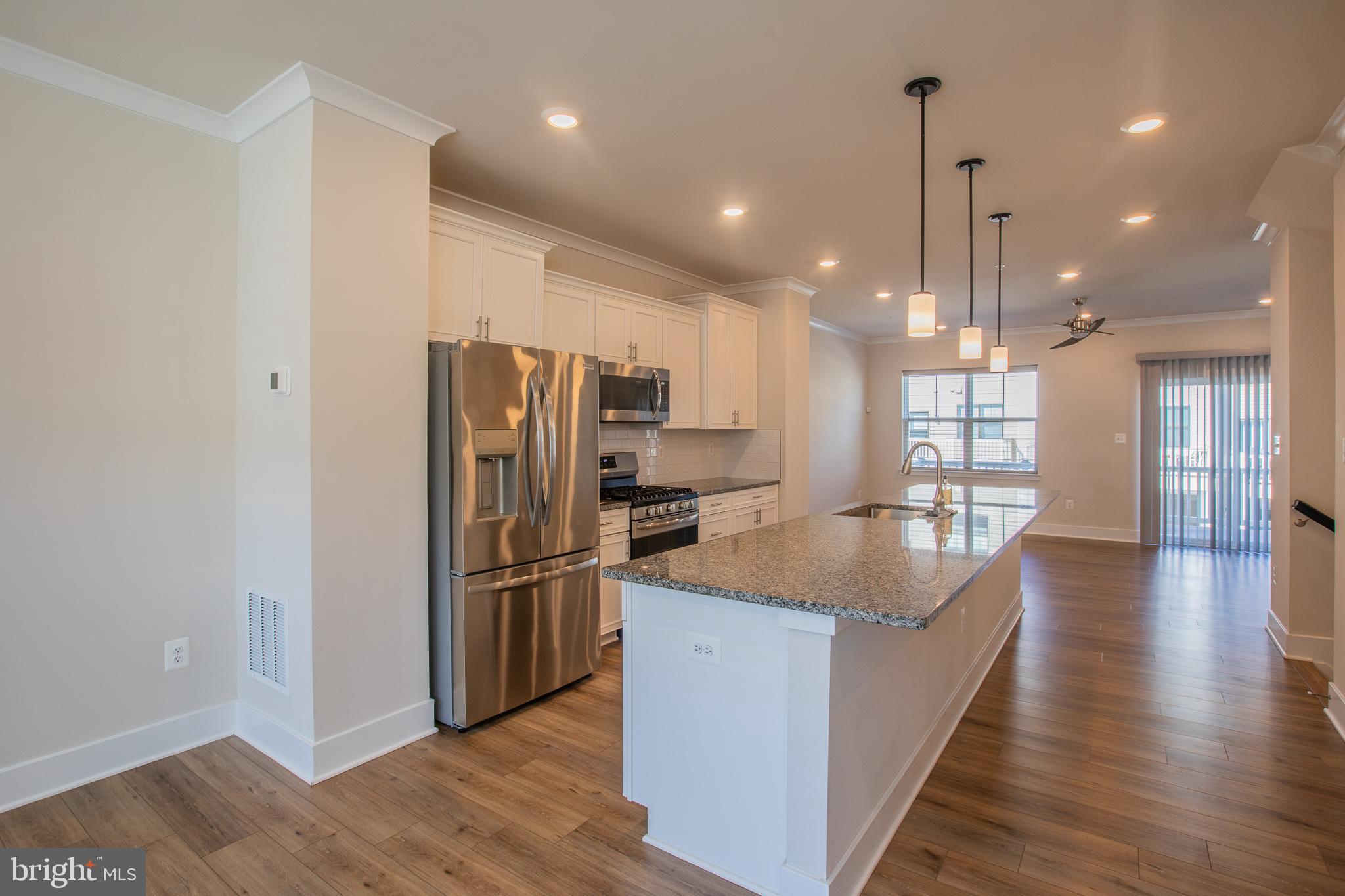 826 Teacher MItchell Road Glen Burnie, MD 21060 - Photo 13 of 41 a kitchen with stainless steel appliances granite countertop a refrigerator a sink and a oven