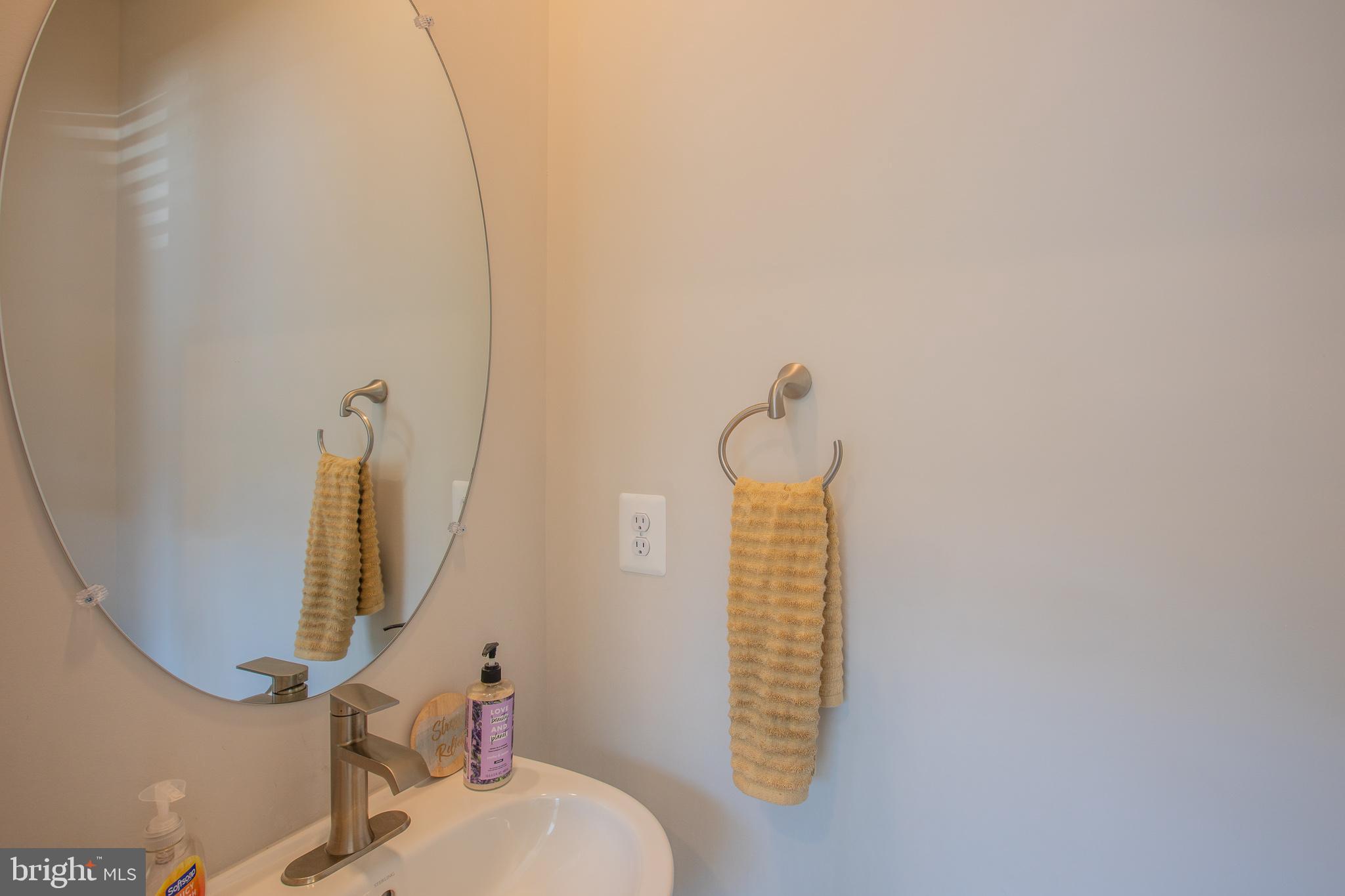 826 Teacher MItchell Road Glen Burnie, MD 21060 - Photo 30 of 41 a bathroom with a sink and a mirror