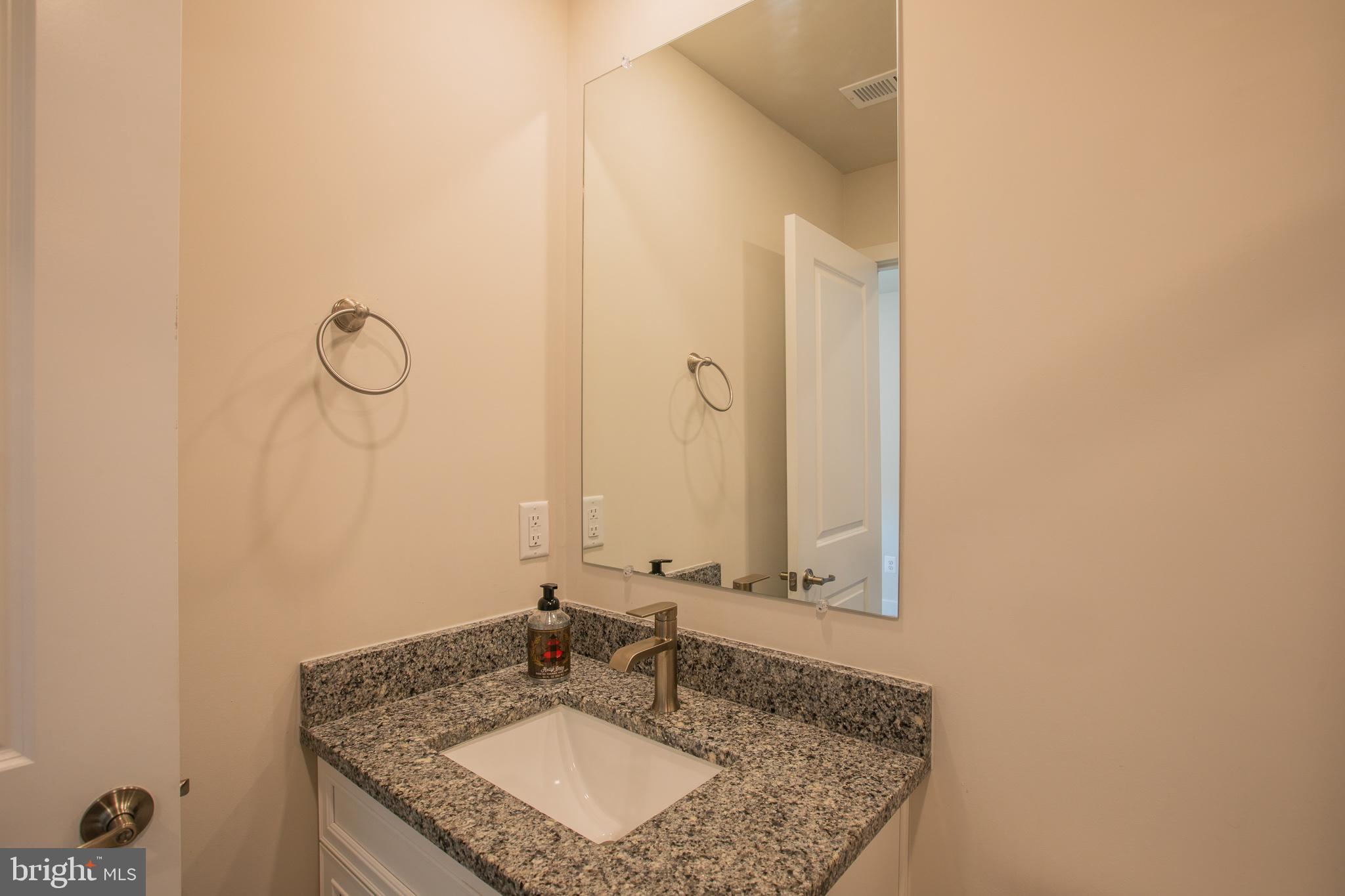 826 Teacher MItchell Road Glen Burnie, MD 21060 - Photo 31 of 41 a bathroom with a granite countertop sink and a mirror