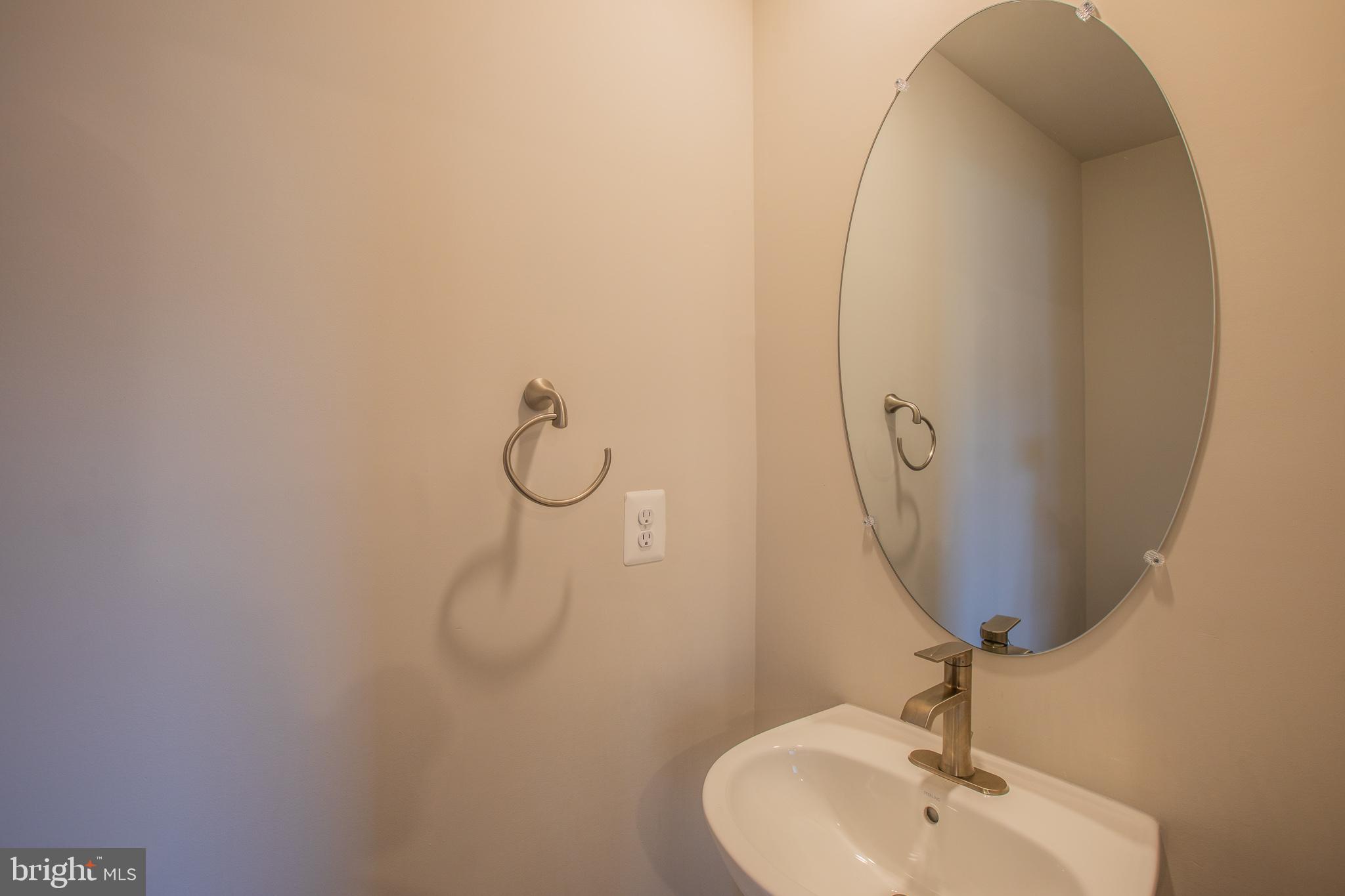 826 Teacher MItchell Road Glen Burnie, MD 21060 - Photo 32 of 41 a bathroom with a sink and mirror