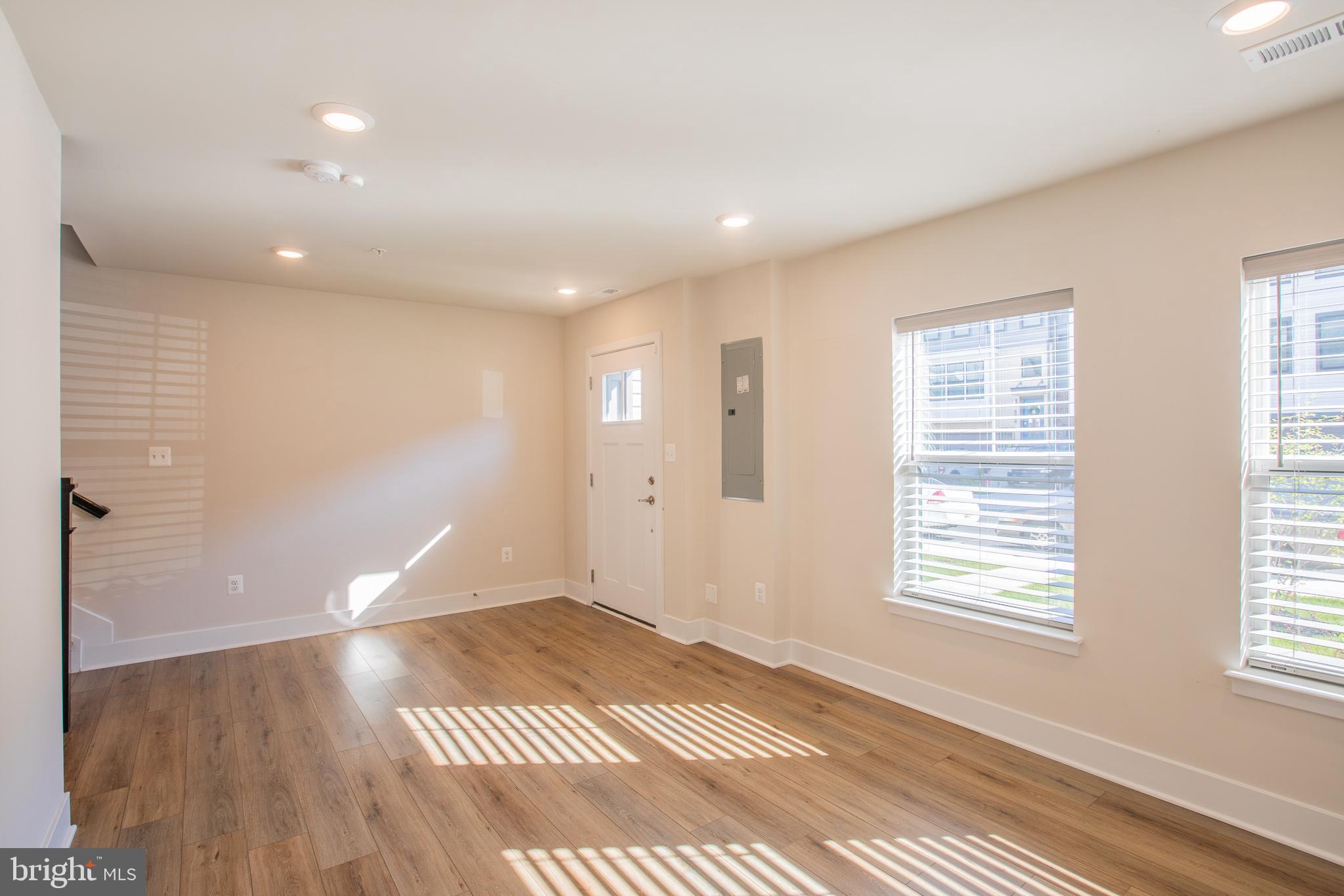 826 Teacher MItchell Road Glen Burnie, MD 21060 - Photo 6 of 41 a view of an empty room with wooden floor and a window
