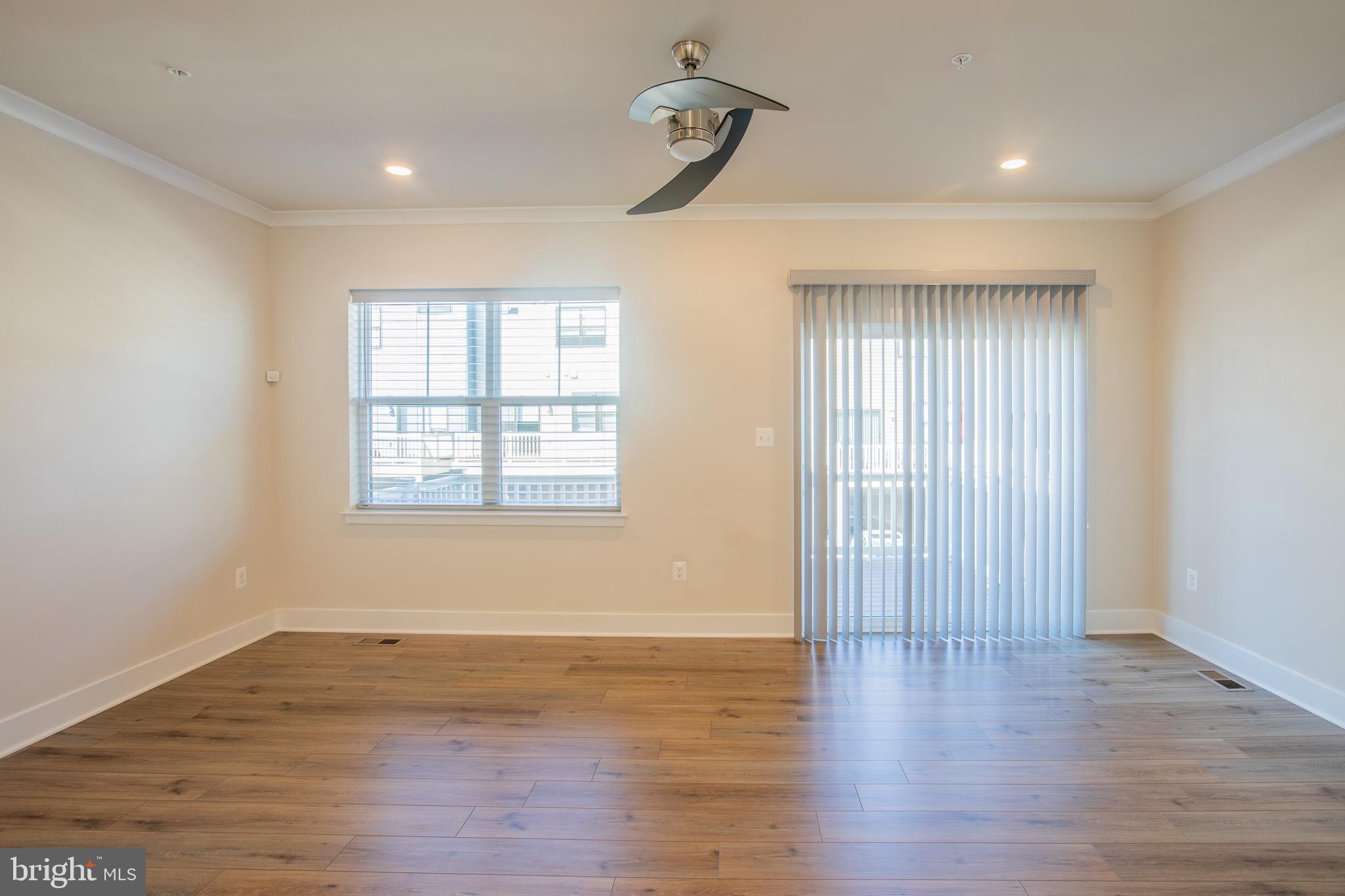 826 Teacher MItchell Road Glen Burnie, MD 21060 - Photo 7 of 41 wooden floor in an empty room with a window