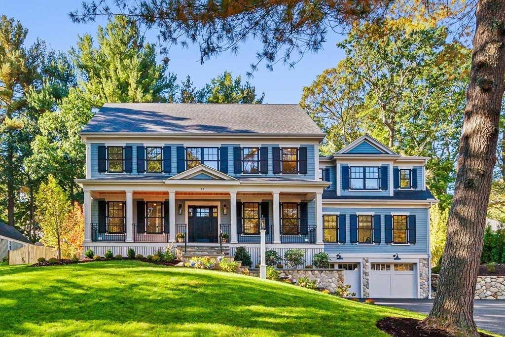 front view of a brick house with a yard