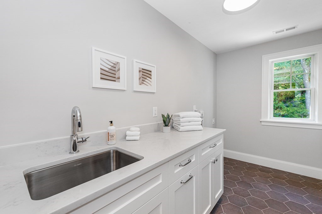 37 Woodland Road Lexington, MA 02420 - Photo 19 of 40 a view with a sink a mirror and a window