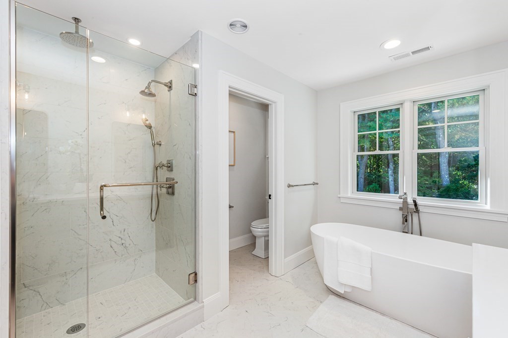 37 Woodland Road Lexington, MA 02420 - Photo 22 of 40 a bathroom with a bathtub and a shower