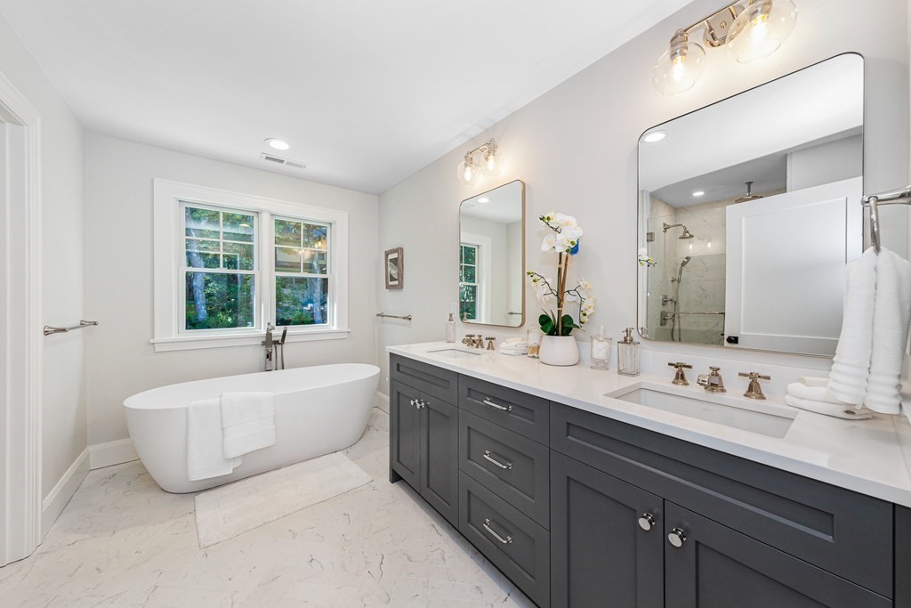 37 Woodland Road Lexington, MA 02420 - Photo 23 of 40 a spacious bathroom with a tub double sink and mirror