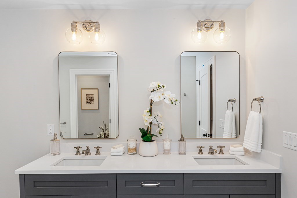 37 Woodland Road Lexington, MA 02420 - Photo 24 of 40 a bathroom with double vanity sinks and a mirror
