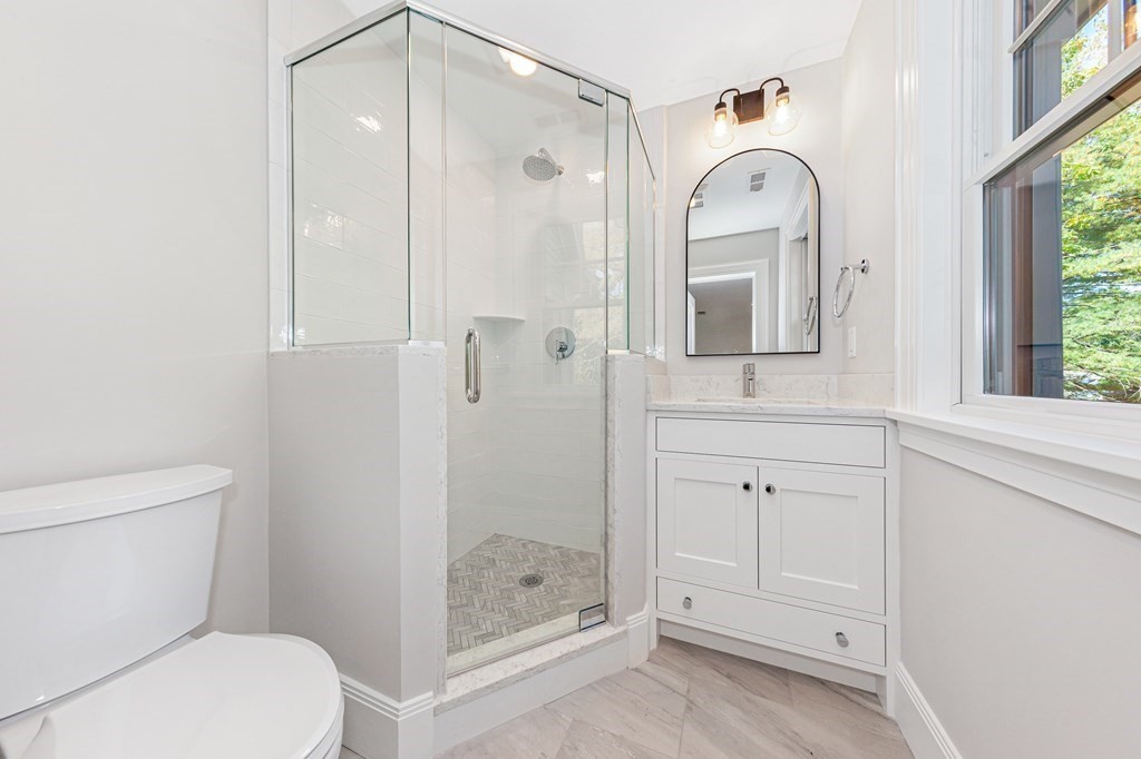 37 Woodland Road Lexington, MA 02420 - Photo 27 of 40 a bathroom with a shower a toilet and a sink