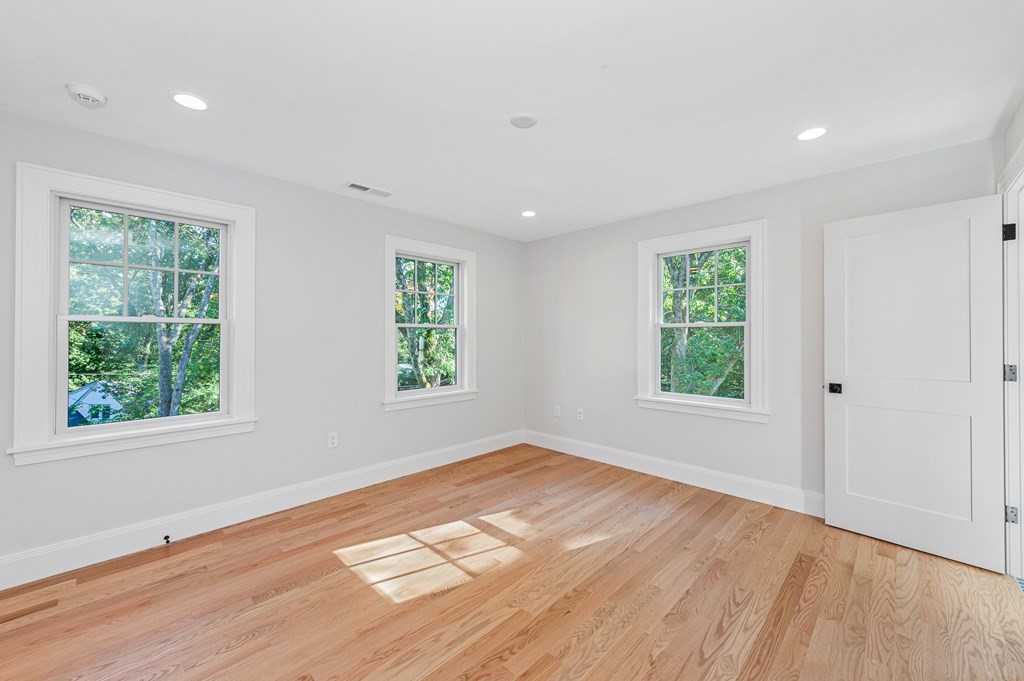 37 Woodland Road Lexington, MA 02420 - Photo 28 of 40 an empty room with wooden floor and windows