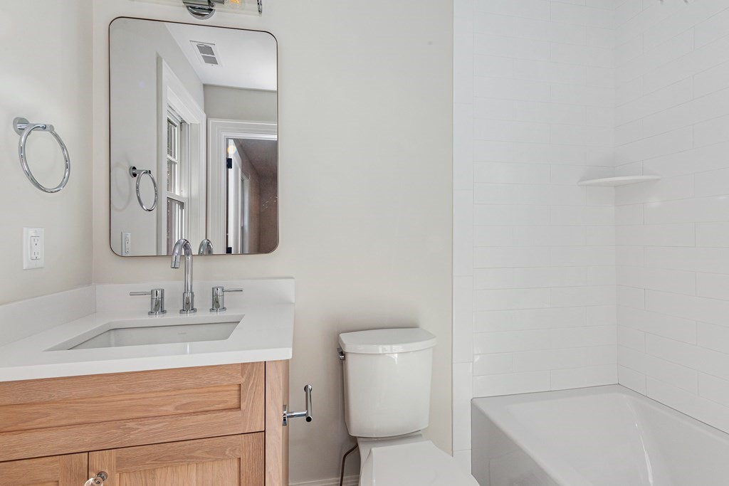 37 Woodland Road Lexington, MA 02420 - Photo 29 of 40 a bathroom with a sink vanity mirror and toilet