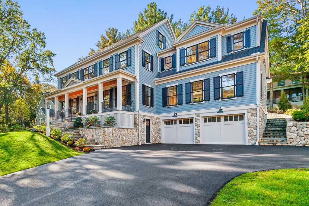 37 Woodland Road Lexington, MA 02420 - Photo 3 of 40 a front view of a building with a garden and trees