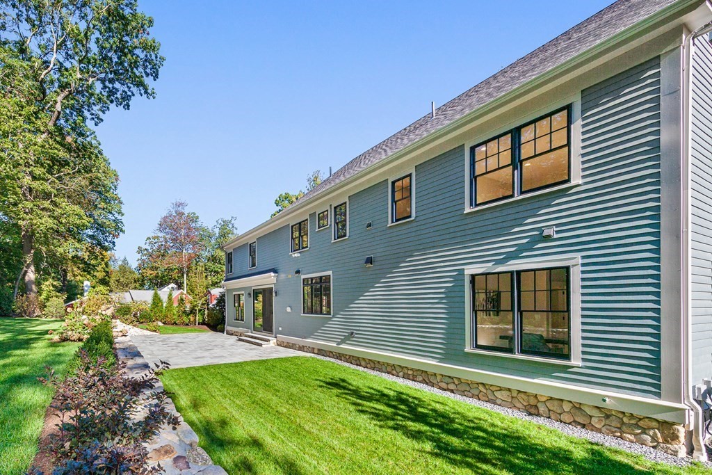 37 Woodland Road Lexington, MA 02420 - Photo 39 of 40 a front view of a house with a yard