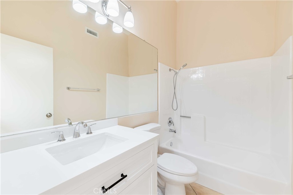 40048 Villa Venecia Temecula, CA 92591 - Photo 19 of 36 a bathroom with a sink a toilet and a large mirror