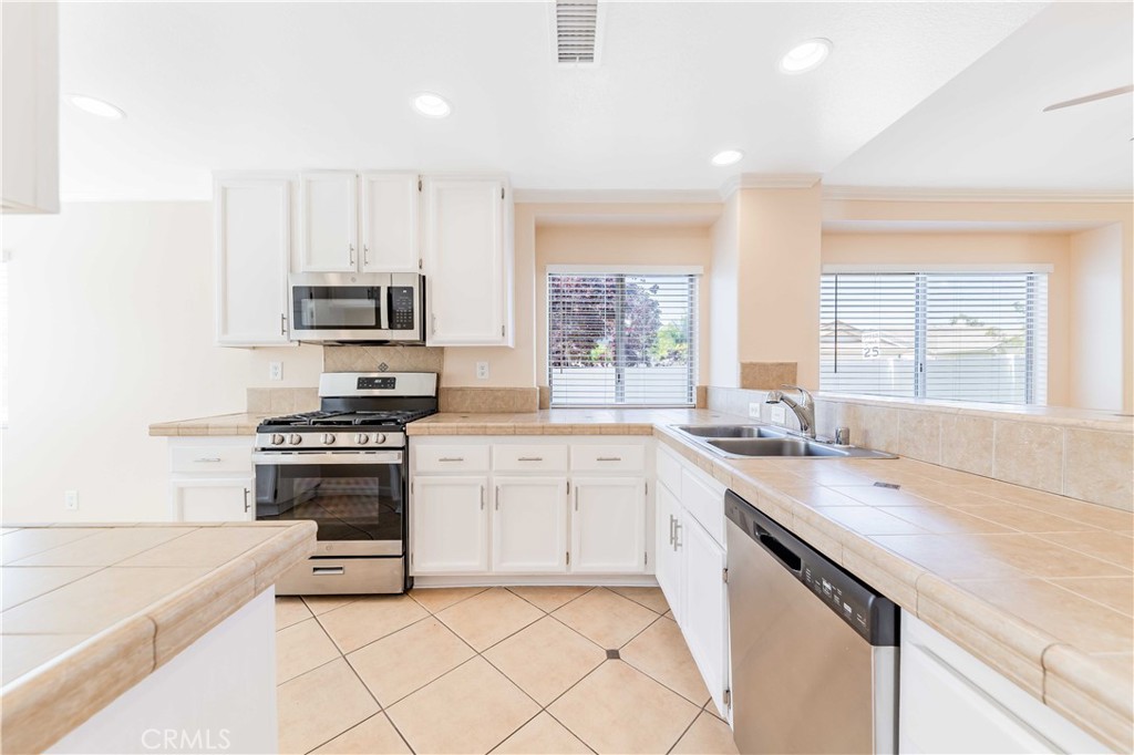 40048 Villa Venecia Temecula, CA 92591 - Photo 6 of 36 a kitchen with stainless steel appliances granite countertop a stove a sink and a microwave