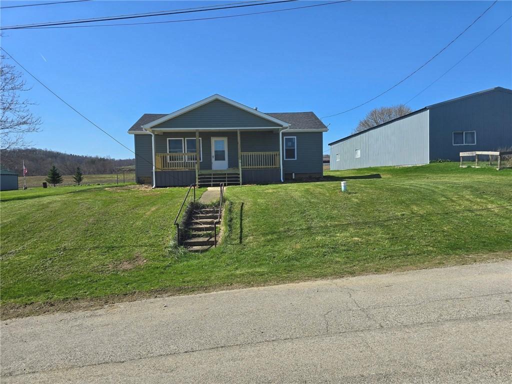 4161 Maple Street Hawthorn, PA 16230 - Photo 1 of 27 a front view of a house with a yard