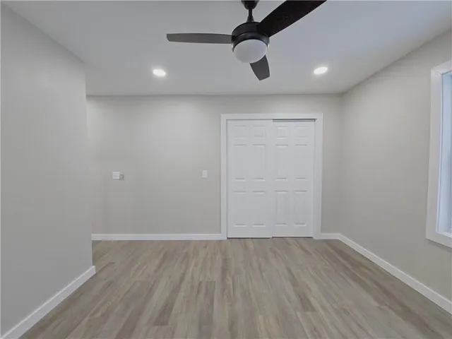 an empty room with a empty space and chandelier fan