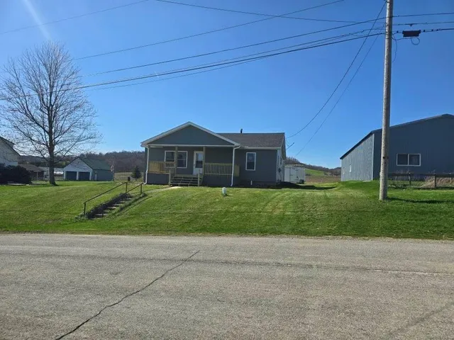 a front view of house with yard and green space