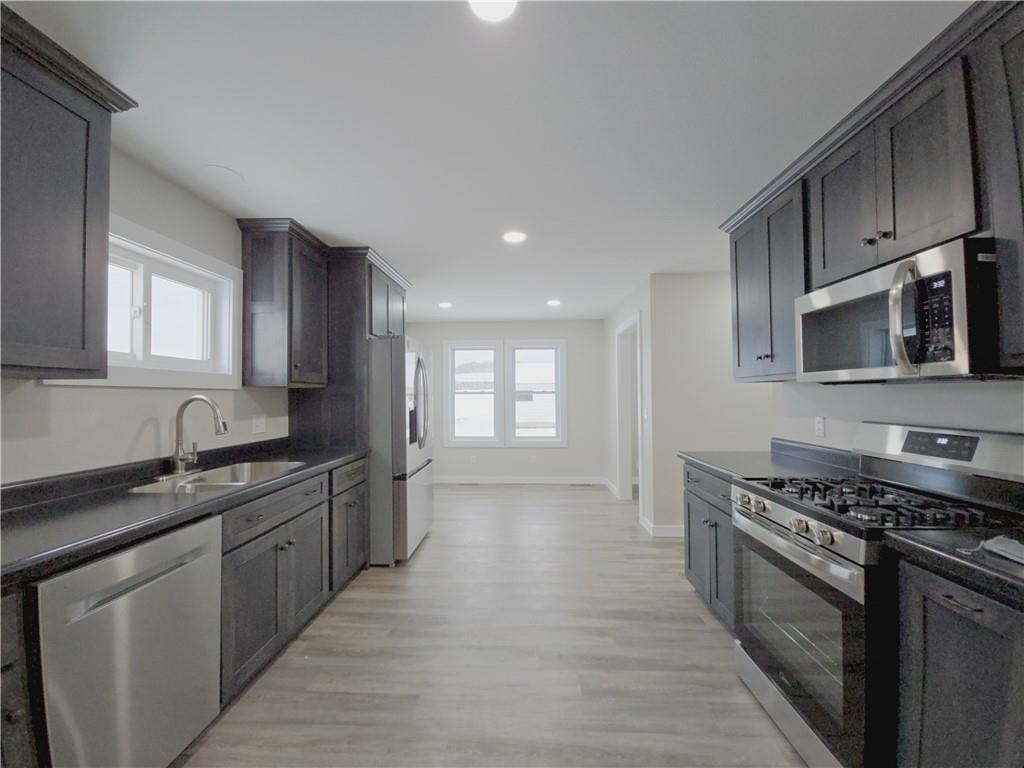 4161 Maple Street Hawthorn, PA 16230 - Photo 7 of 27 a kitchen with stainless steel appliances a sink stove and cabinets