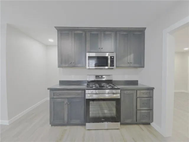 a kitchen with a stove and a microwave
