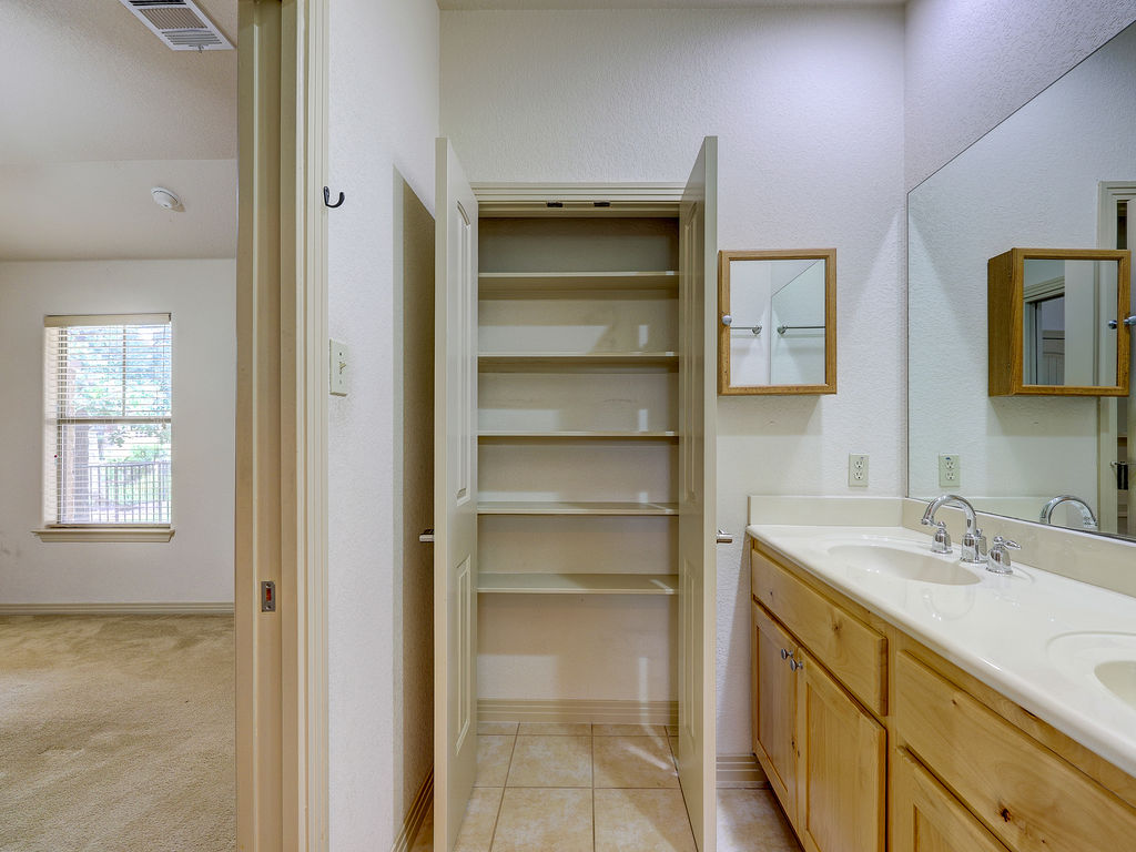 9707 Anderson Mill Road, Unit 22 Austin, TX 78750 - Photo 35 of 39 Double vanity and a spacious linen closet streamline your morning routine.