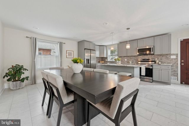 a view of a dining room kitchen with a table and chairs