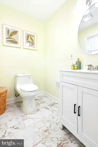 a bathroom with a sink toilet and mirror