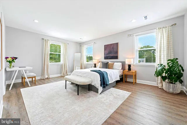 a bedroom with a bed a table and chair