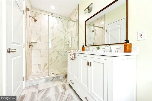 a bathroom with a bathtub and a shower