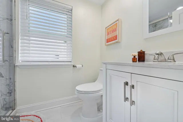 a bathroom with a toilet a sink and a window