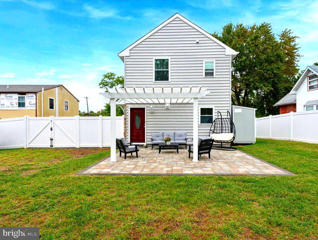 a view of backyard of house with sitting area