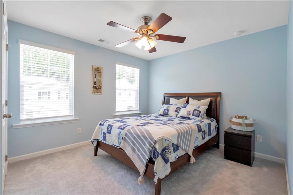 660 Groover Street Ball Ground, GA 30107 - Photo 30 of 53 a bedroom with a bed and window