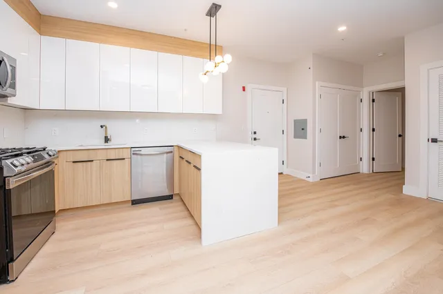 a kitchen with white cabinets and white appliances