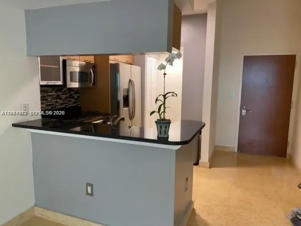 a view of a living room with a sink and mirror