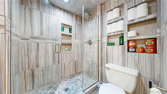 a white toilet sitting next to a bathroom